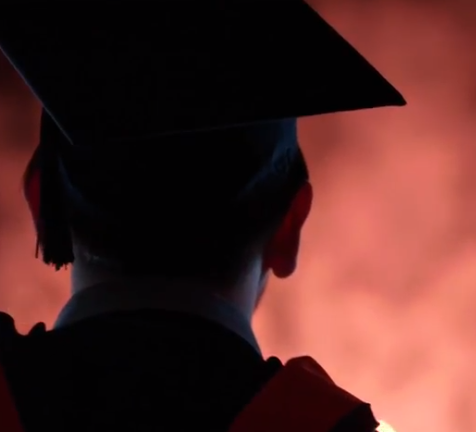 Graduate watching fireworks display at the 2018 commencement exercise at Citizens Bank Park